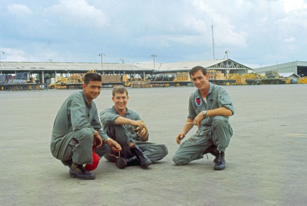 Joe Basilisco, Flight Engineer, Jerry Willard, Loadmaster, Jon Alexander, Navigator, on the ramp at Tan Son Nhut air base.